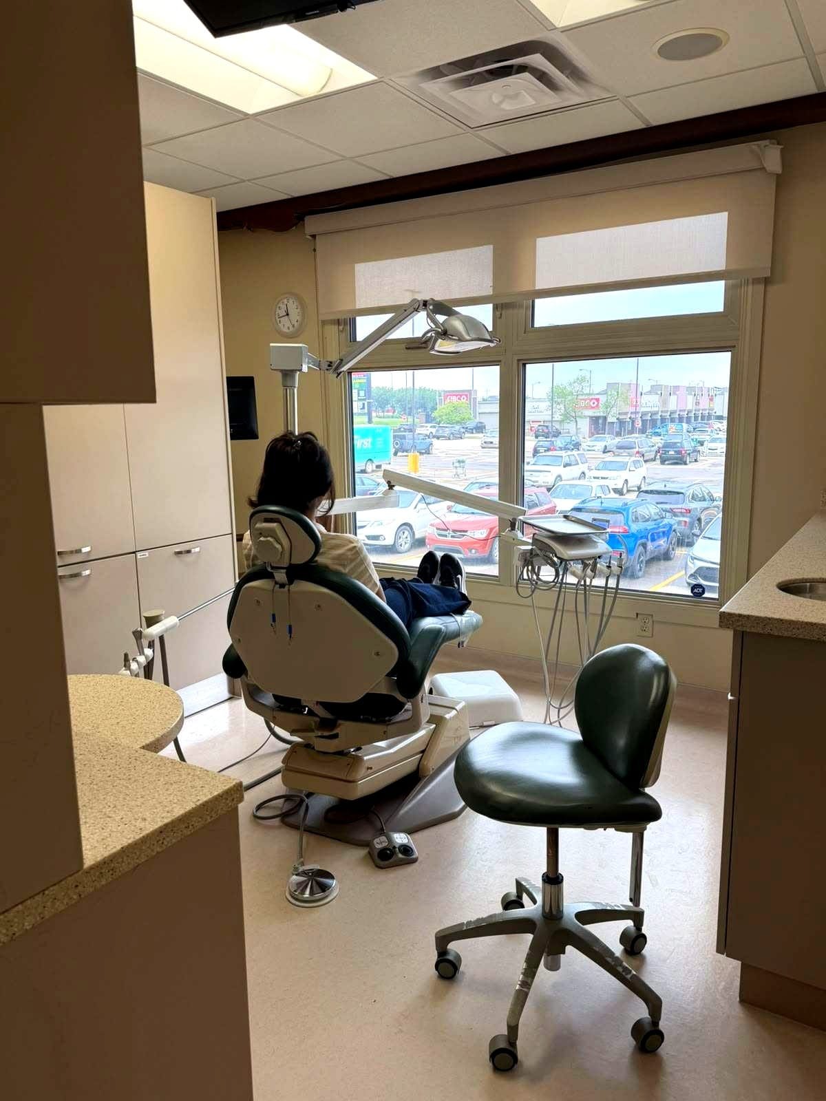 Dental operatory with patient chair overlooking the parking lot windows